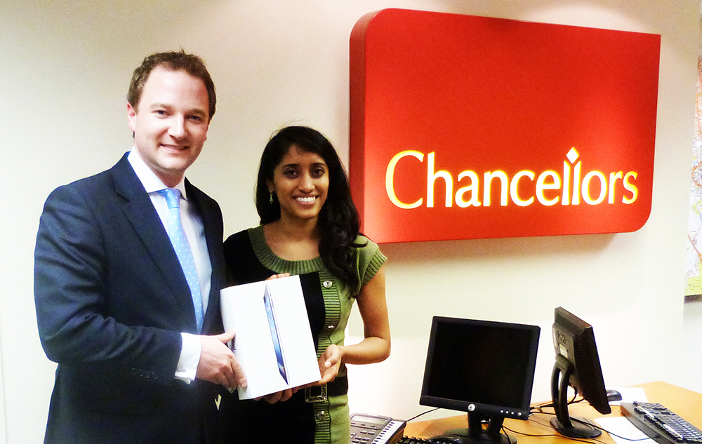 Pavitra Kannan collects her iPad from Chancellors Associate Director for Headington Lettings Jonathan Pincott