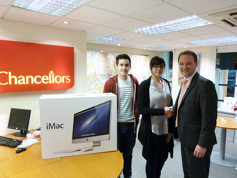 Chancellors' Jonathan Pincott presents an Apple iMac to our competition winner